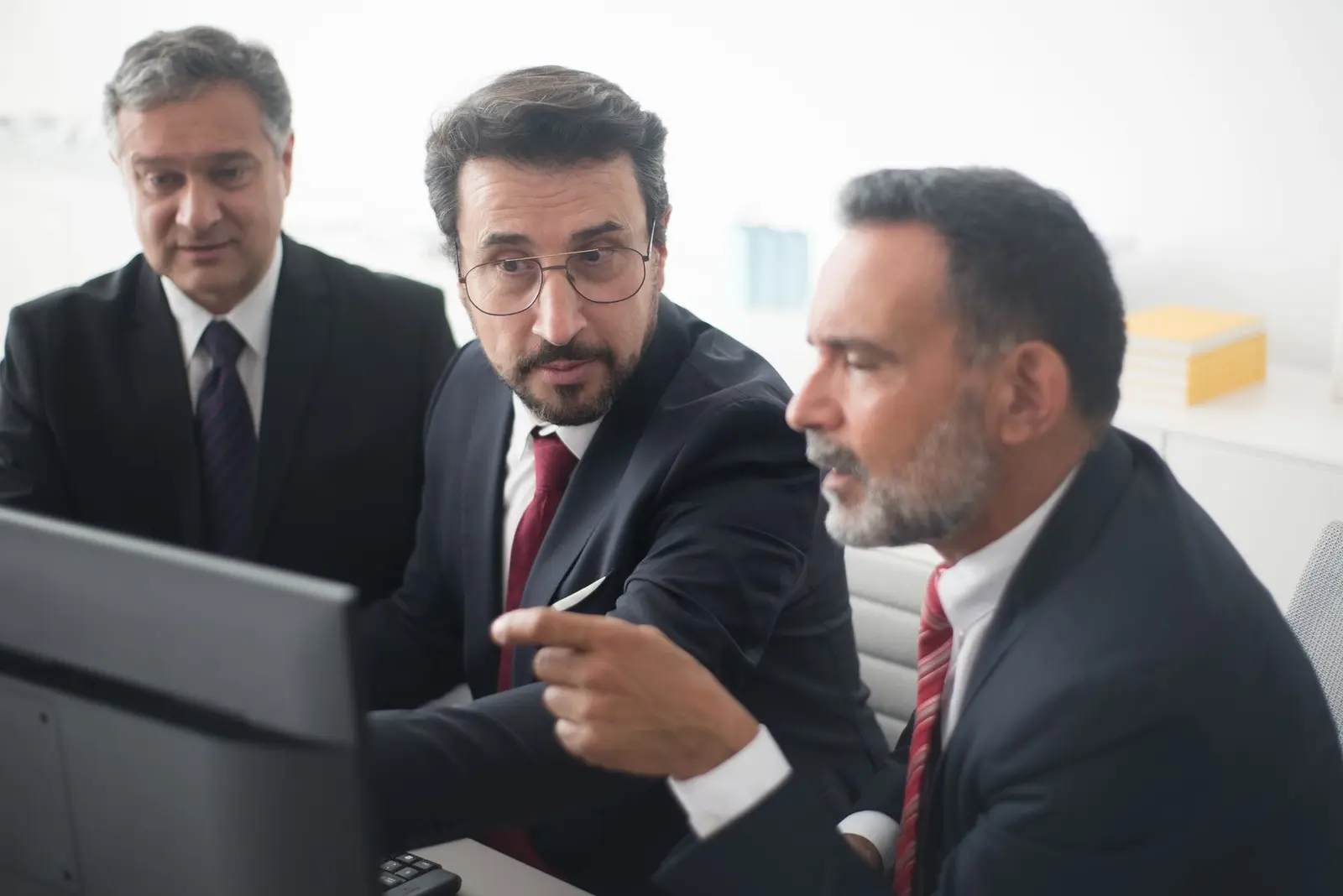 Technical specialists reviewing information together on a computer