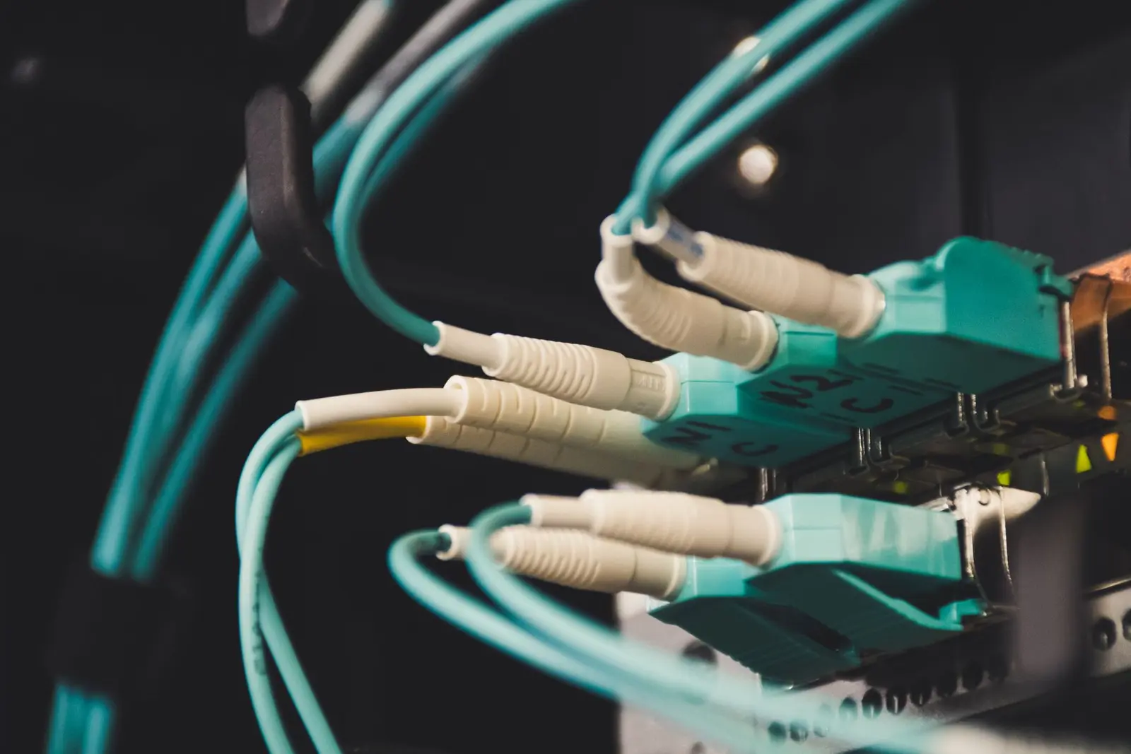 Close view of connected fiber cables carrying application traffic