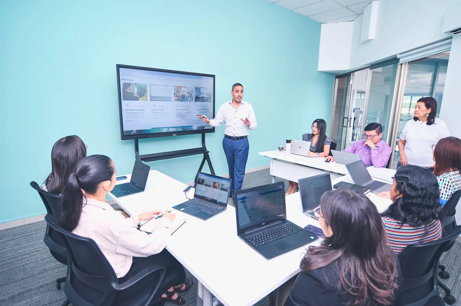 Infrastructure team reviewing a technical presentation in a modern workplace