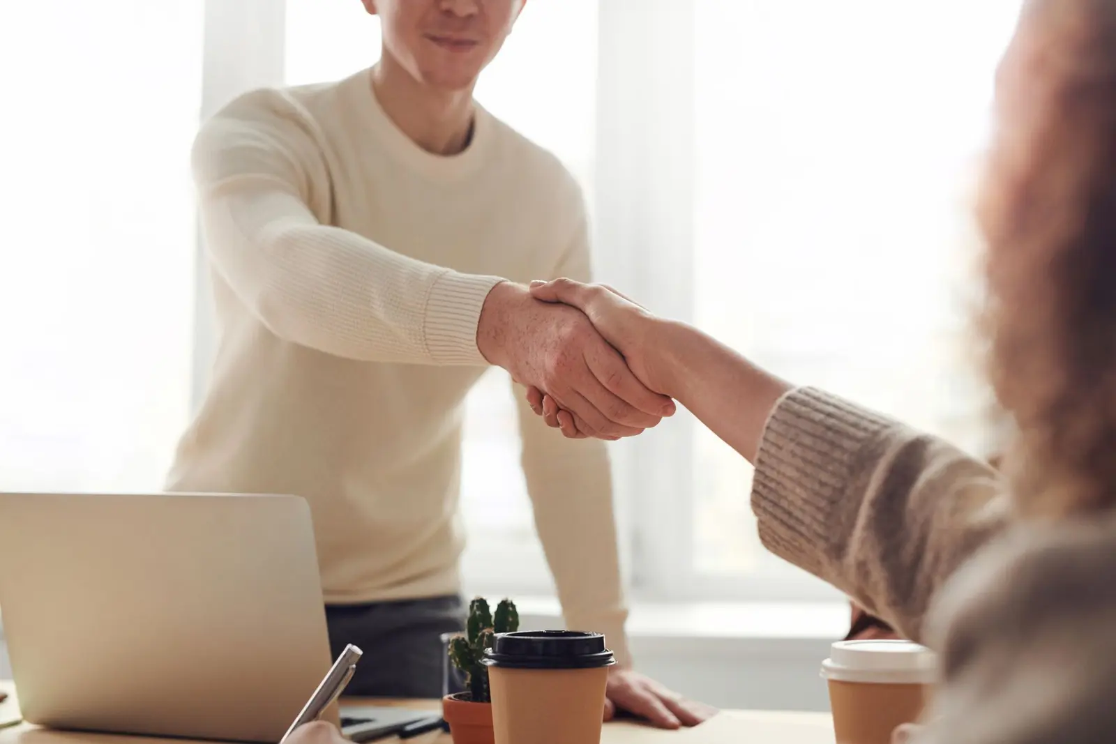 Business professionals beginning a focused technical consultancy meeting