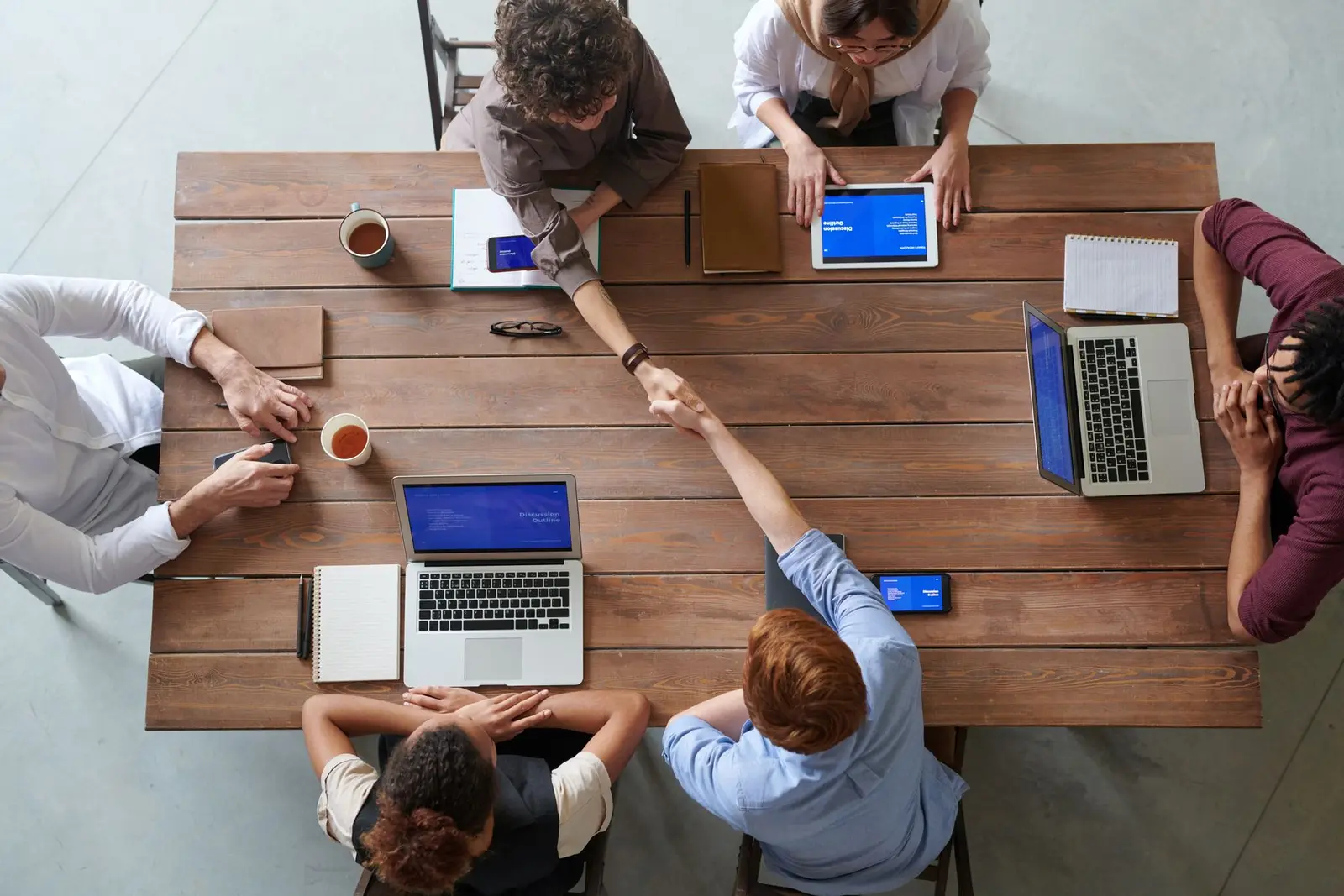 People from different roles collaborating around digital work tools