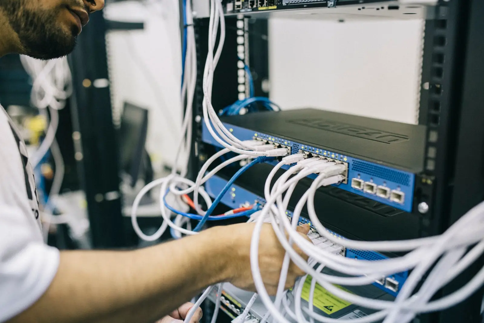 Network engineer working with structured cabling and enterprise networking equipment